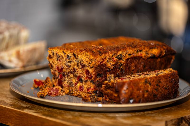 A sliced fruit loaf studded with cherries and dried fruit